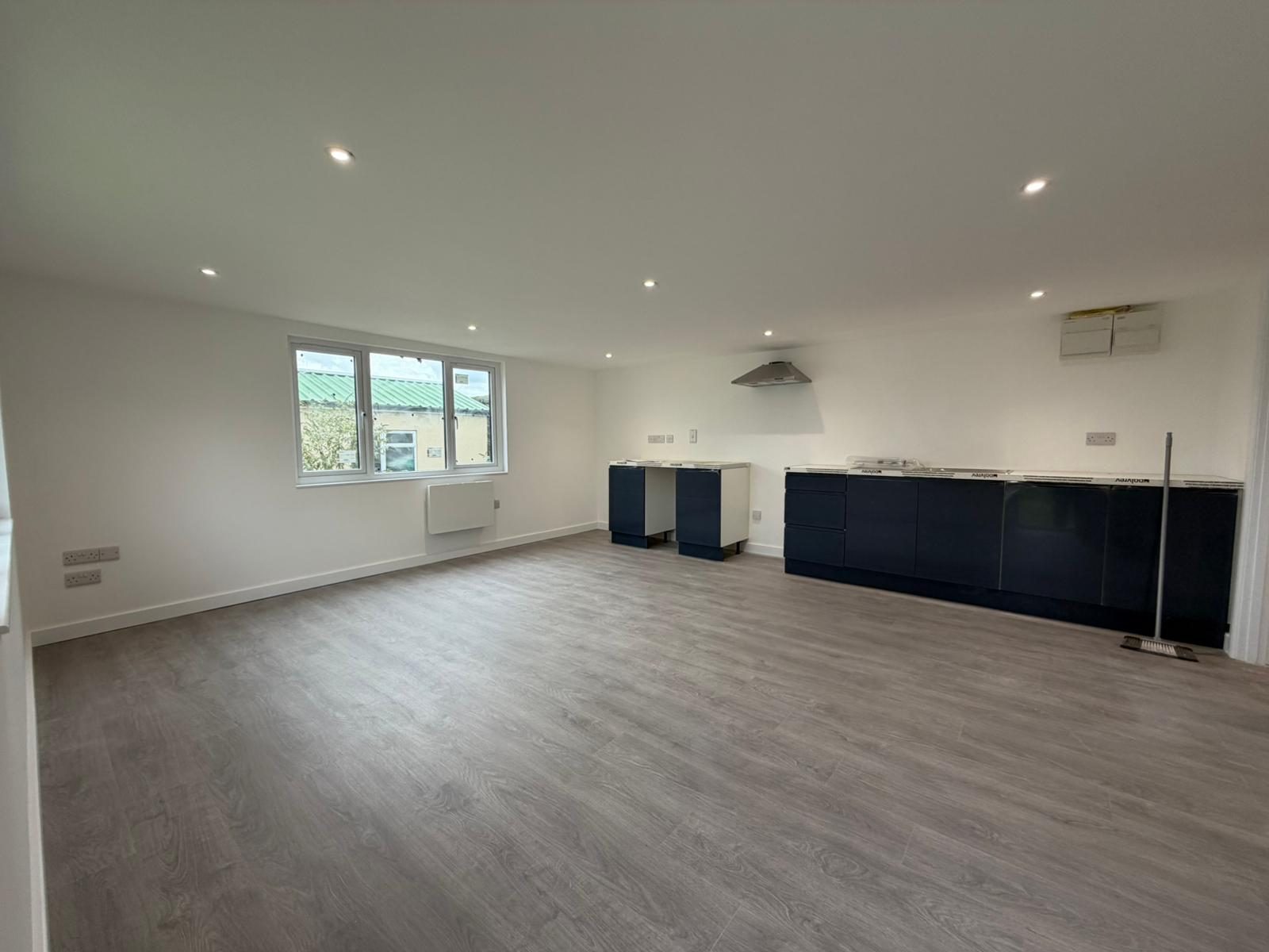 Open-plan room with fitted kitchen — JLG Construction Services