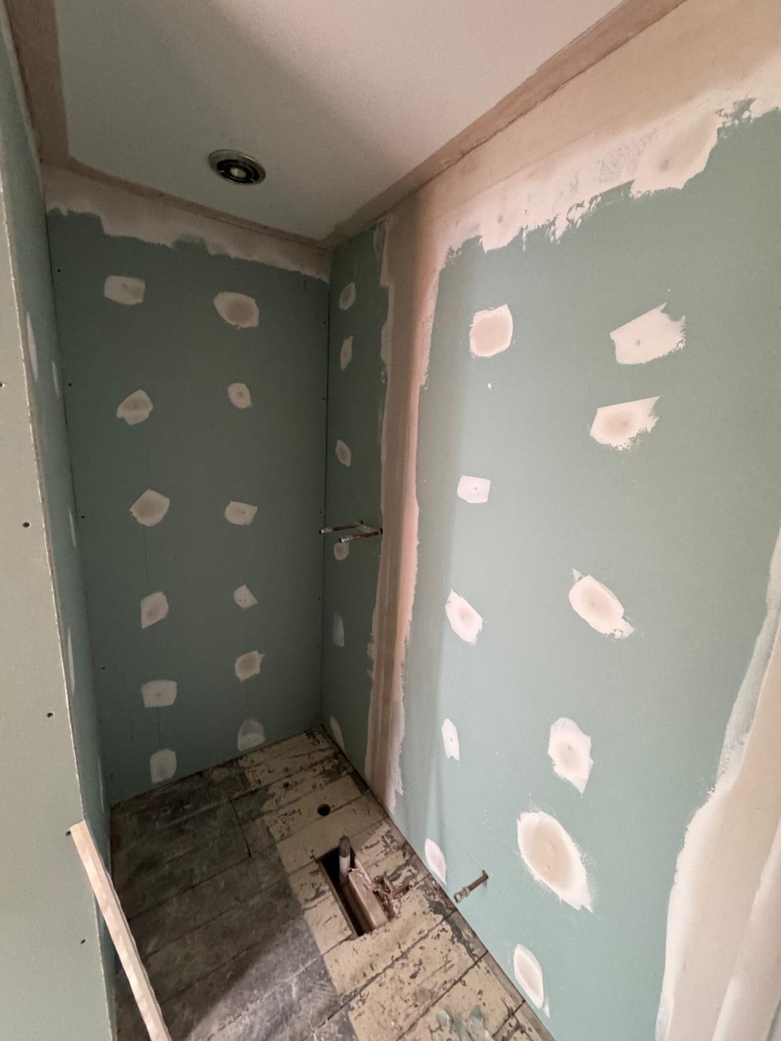 Moisture-resistant boarding to the new en-suite walls, JLG Construction Services