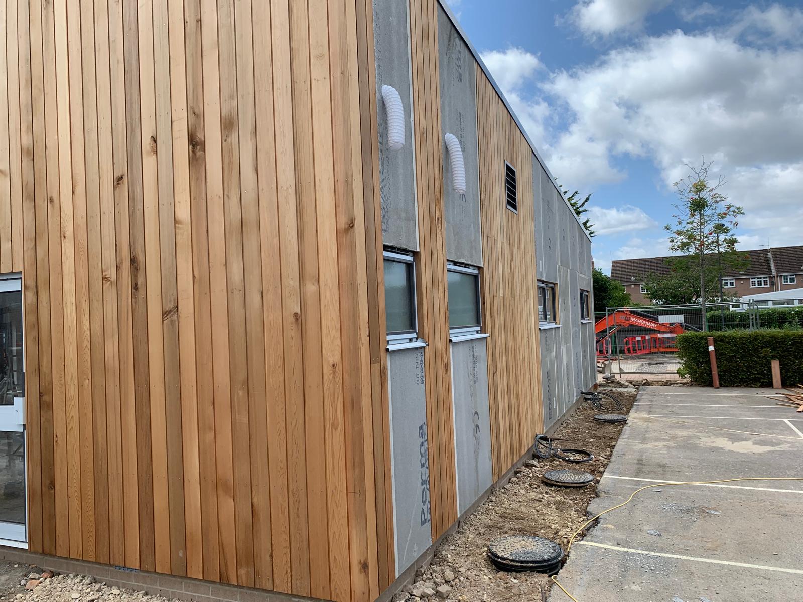 Vertical timber cladding along the elevation, Wimborne School, JLG Construction Services